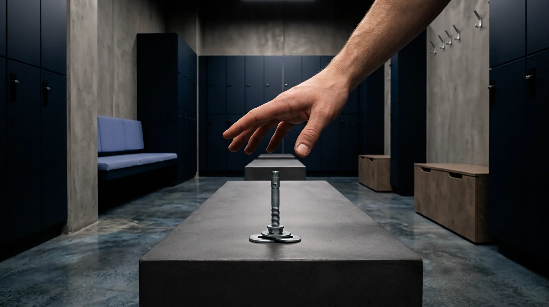 A digital render displays a steel expansion bolt assembly on a concrete bench inside a dark blue industrial locker room.
